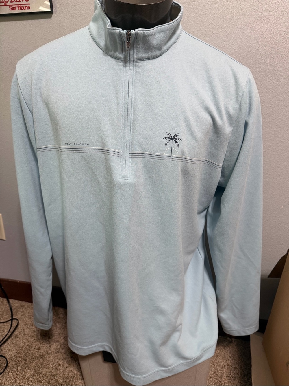 Travis Mathew Light Blue Quarter-Zip Pullover with Subtle Palm Detail